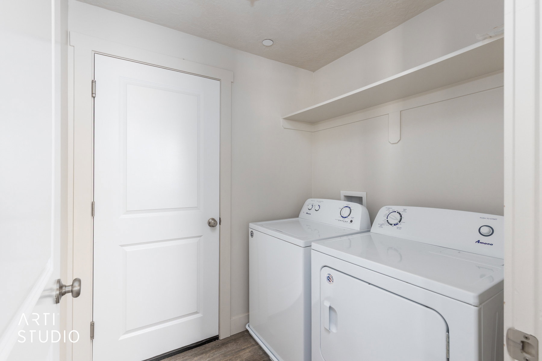 Laundry room featuring washing machine and clothes dryer and wood finished floors