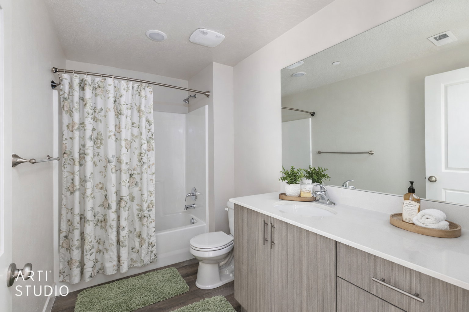 Bathroom with vanity, shower / tub combo with curtain, dark wood finished floors, and a textured ceiling
