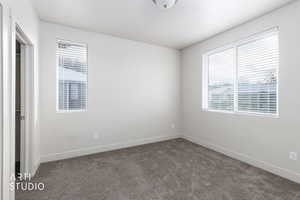 Unfurnished bedroom with carpet floors and baseboards