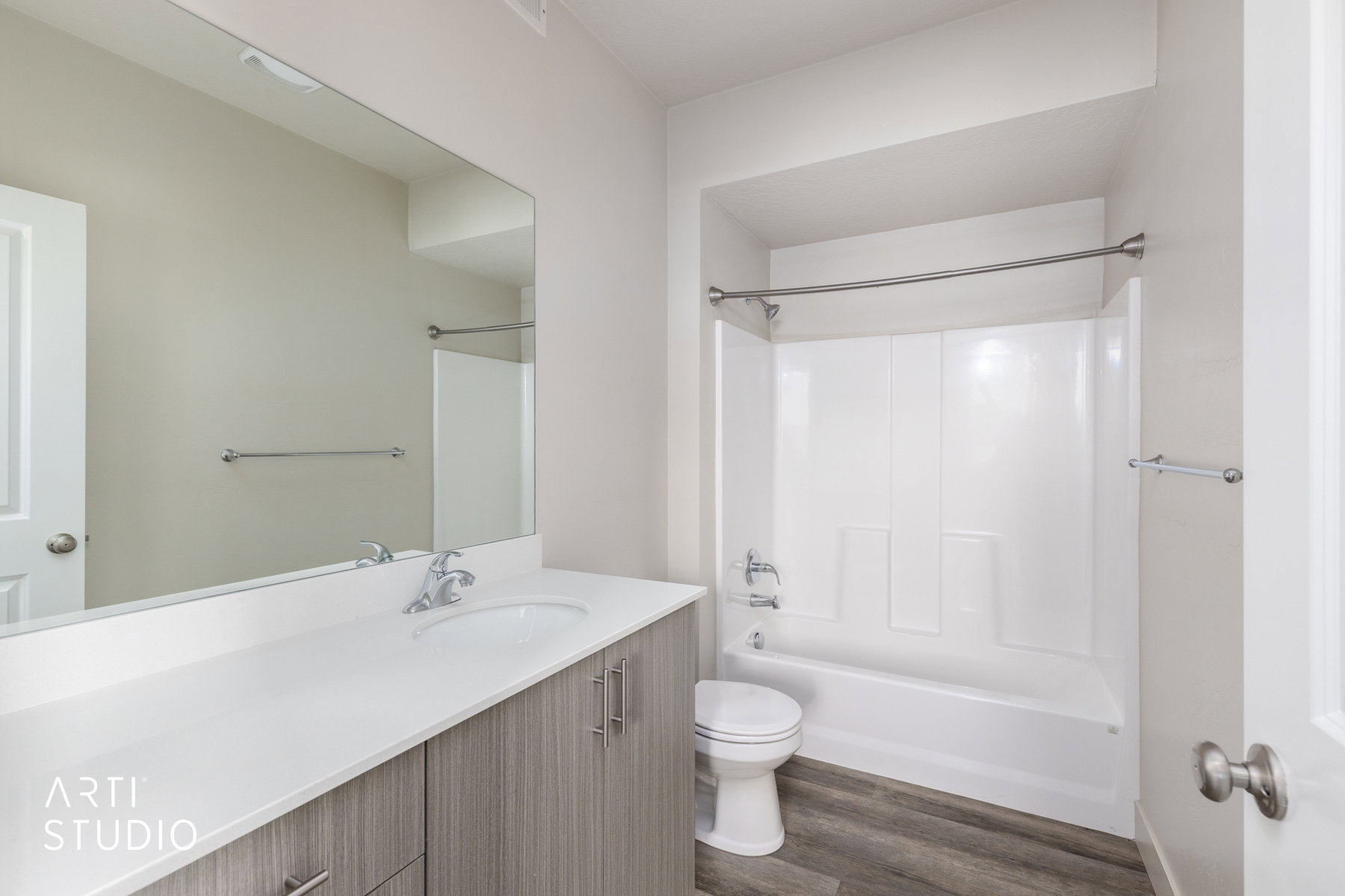 Full bathroom featuring shower / bathtub combination, vanity, and dark wood-type flooring
