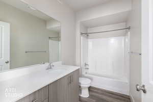 Full bathroom featuring shower / bathtub combination, vanity, and dark wood-type flooring