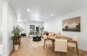 Dining area with wood finished floors and recessed lighting