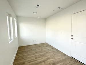 Empty room featuring wood finished floors and baseboards