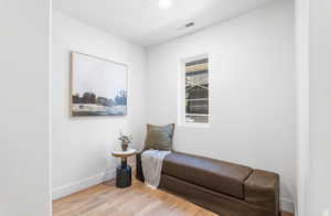 Sitting room featuring light wood-type flooring and baseboards