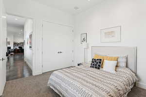 Bedroom featuring recessed lighting, dark carpet, and a closet