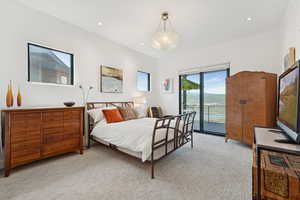 Bedroom with light carpet, access to exterior, and recessed lighting