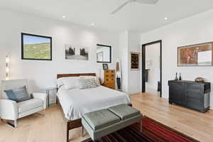 Bedroom featuring light wood-style floors, a ceiling fan, and recessed lighting