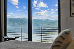 Bedroom with a water and mountain view