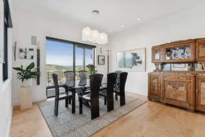 Dining space with light wood finished floors and recessed lighting