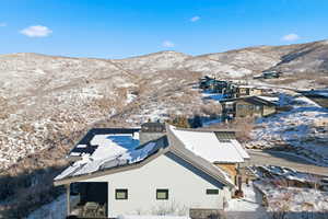 Snowy aerial view featuring a mountain view