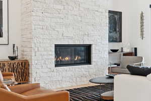 Living room with a stone fireplace