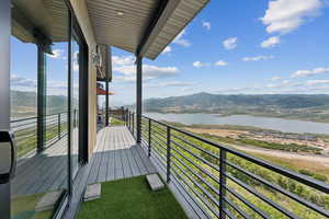 Balcony with a water and mountain view