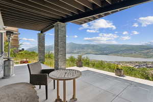 View of patio featuring a water and mountain view