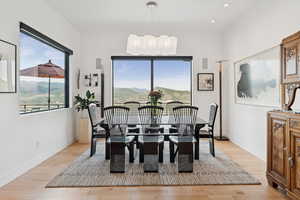 Dining space featuring light wood-style floors, a mountain view, and healthy amount of natural light