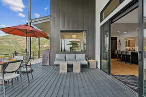 Wooden terrace featuring an outdoor living space, outdoor dining space, and area for grilling