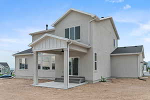 Back of property featuring a patio area, stucco siding, and ceiling fan