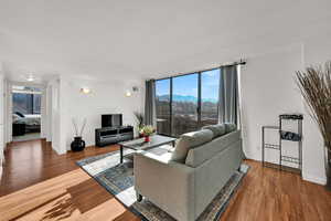Open living room featuring LVP floors, abundant natural light, and balcony access