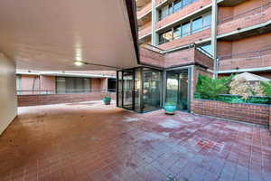 Doorway to property featuring brick siding