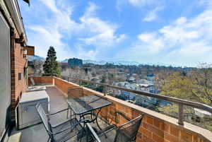 Balcony featuring a mountain view and outdoor dining area
