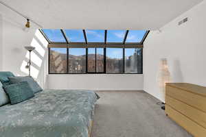 Large primary bedroom with huge greenhouse windows, and incredible east-facing mountain views