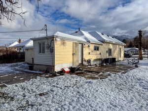 Snow covered house with a patio