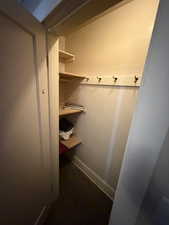 Mudroom with dark colored carpet and baseboards