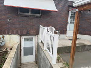 Doorway to property with brick siding