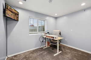 Home office featuring dark carpet and recessed lighting