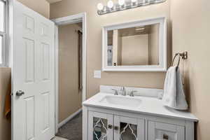 Bathroom featuring vanity and carpet