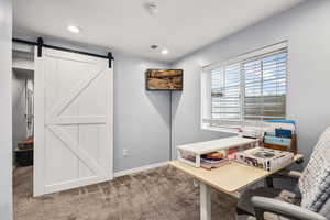 Carpeted office space featuring baseboards and recessed lighting