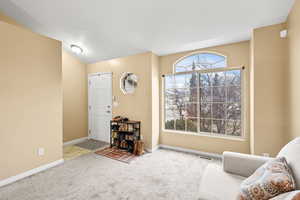 Living area featuring baseboards and carpet flooring