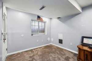 Empty room with baseboards and carpet floors
