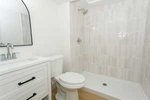 Bathroom with vanity and tiled shower
