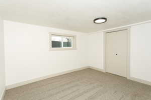 Unfurnished bedroom with a closet, carpet flooring, and a textured ceiling