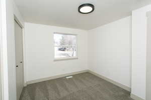 Spare room with carpet floors and baseboards