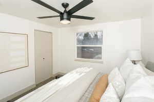 Bedroom with a ceiling fan and baseboards