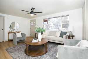Living room featuring wood finished floors and ceiling fan