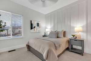 Bedroom featuring a decorative wall and a ceiling fan