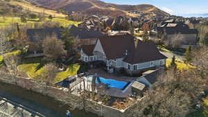 Aerial view of residential area with a pool and a mountain backdrop