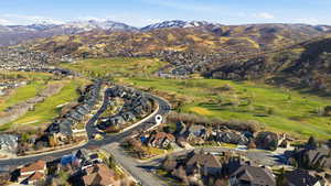 Aerial view of property's location featuring nearby suburban area and a mountainous background