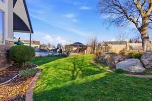 View of yard with a gazebo, a patio, and an outdoor pool