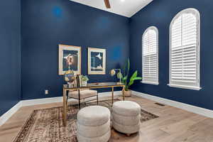 Office with wood finished floors and a ceiling fan