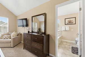 Sitting room with lofted ceiling and baseboards