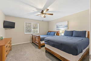 Bedroom with light carpet and a ceiling fan