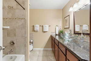 Full bath with vanity, bathing tub / shower combination, and light tile patterned floors