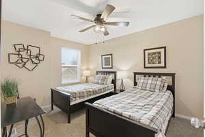 Bedroom featuring light carpet and a ceiling fan