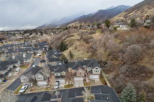 Aerial overview of property's location featuring mountains and nearby suburban area