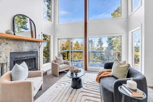 Carpeted living room with a brick fireplace and vaulted ceiling