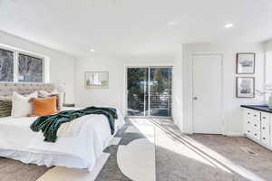 Primary bedroom with doors leading to balcony