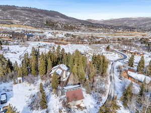 Snowy aerial view featuring a mountain view